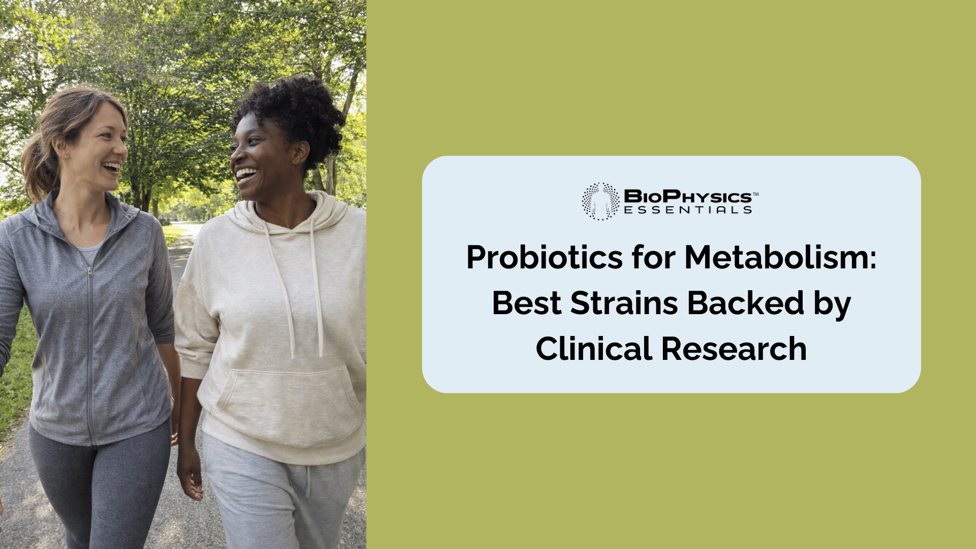 Two women in their mid 30s to late 40s walking and laughing together on a tree-lined park path, representing an active lifestyle approach to metabolic health