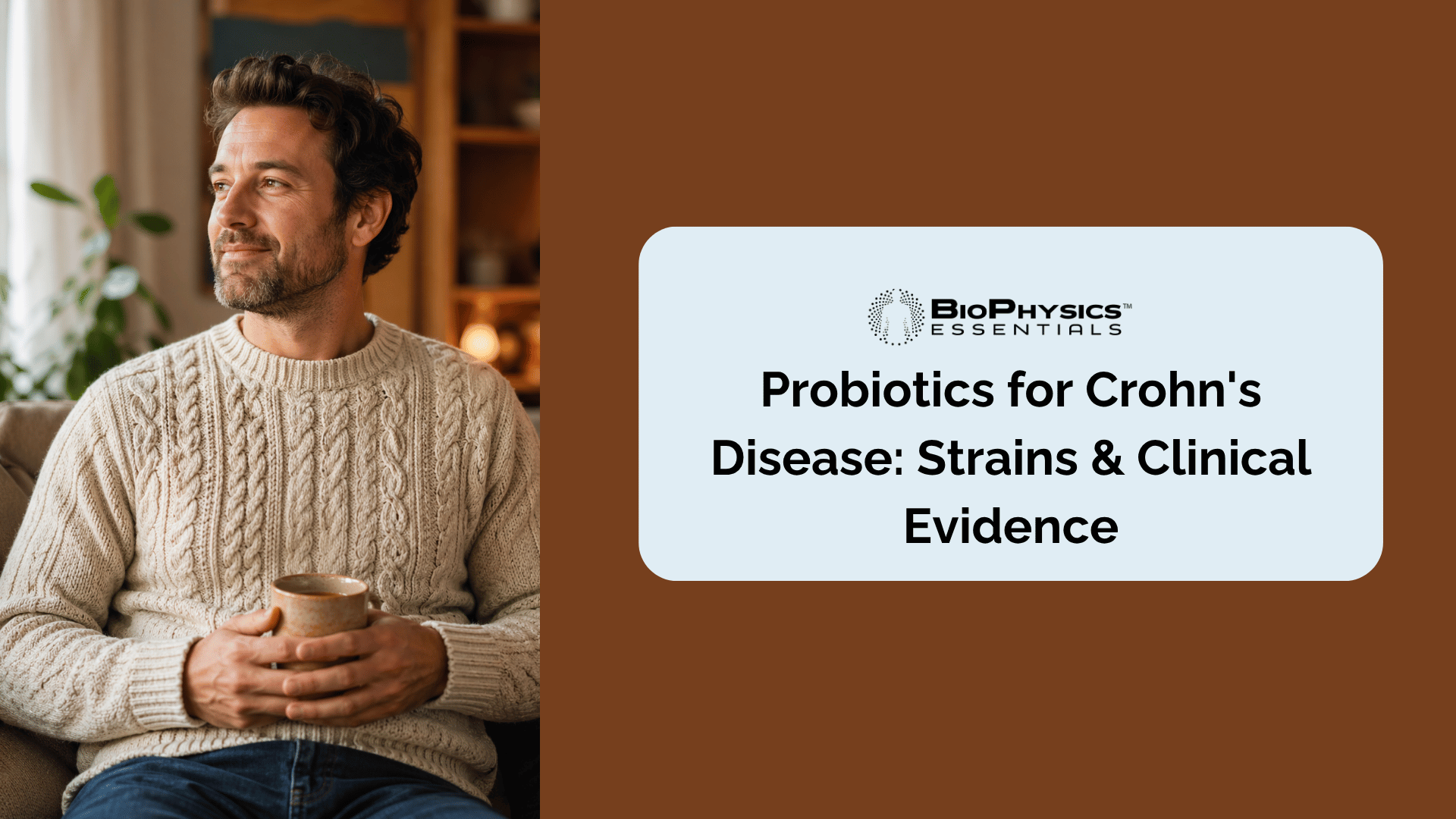 Calm man in his late 30s sitting on a couch in soft morning light holding a warm ceramic mug, with one hand resting on his lower abdomen, representing the experience of someone managing Crohn's disease with intentional gut health support.